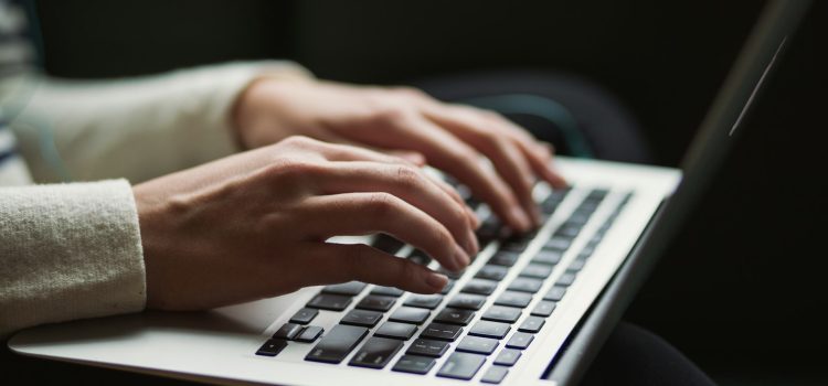 How to Write Title Tags and Meta Descriptions That Get Clicks Hands typing on a laptop keyboard