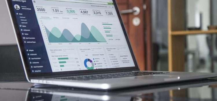 UTM Parameters Explained: Track Where Your Website Visitors Come From A laptop showing an analytics dashboard on a glass table